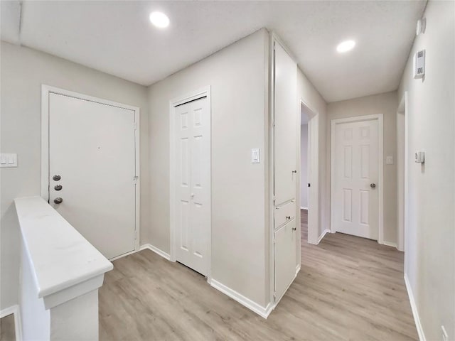 9512 Meadowheath Dr, Austin, TX 78729 - foyer entrance with light wood-type flooring, baseboards, and recessed lighting