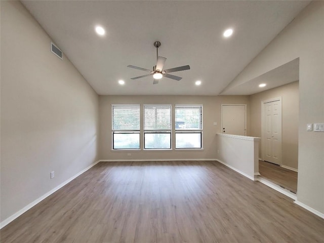 9512 Meadowheath Dr, Austin, TX 78729 - unfurnished room featuring ceiling fan, recessed lighting, vaulted ceiling, wood finished floors, and baseboards