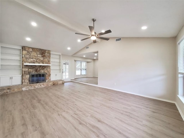 9512 Meadowheath Dr, Austin, TX 78729 - unfurnished living room with a ceiling fan, wood finished floors, a stone fireplace, baseboards, and healthy amount of natural light