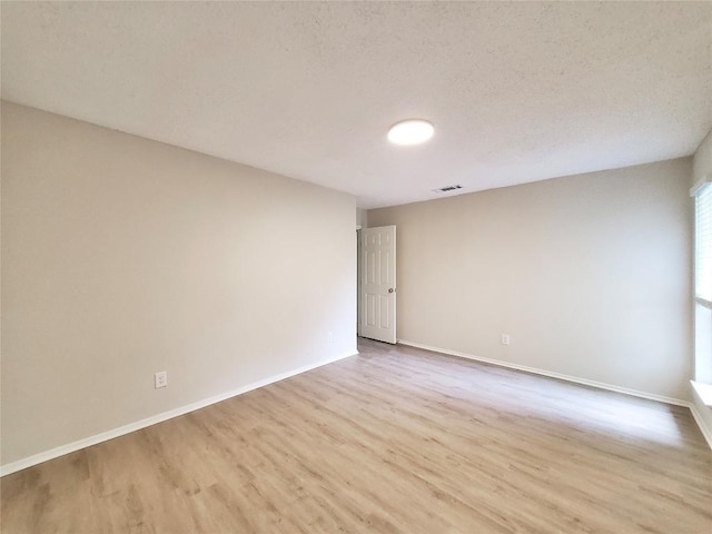 9512 Meadowheath Dr, Austin, TX 78729 - spare room with wood finished floors and baseboards