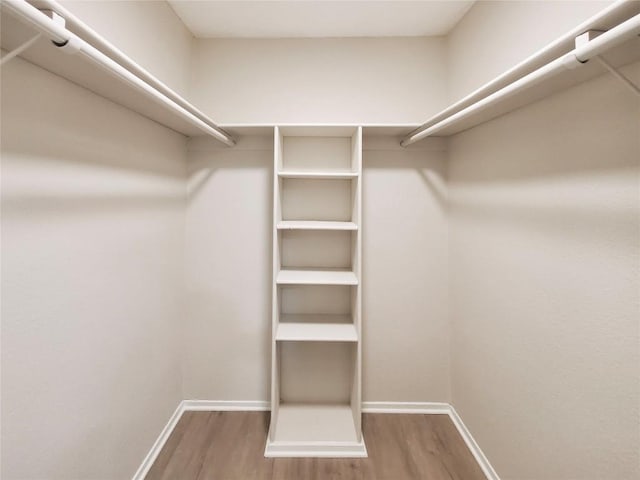 9512 Meadowheath Dr, Austin, TX 78729 - walk in closet featuring wood finished floors