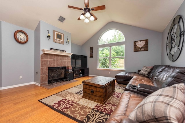 1006 Savanna Ln, Cedar Park, TX 78613 - living room with wood finished floors, vaulted ceiling, ceiling fan, a tiled fireplace, and baseboards