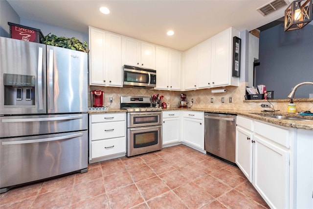 1006 Savanna Ln, Cedar Park, TX 78613 - kitchen featuring appliances with stainless steel finishes, tasteful backsplash, white cabinetry, a sink, and recessed lighting