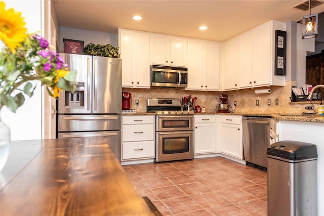 1006 Savanna Ln, Cedar Park, TX 78613 - kitchen with stainless steel appliances, white cabinetry, decorative backsplash, a sink, and recessed lighting