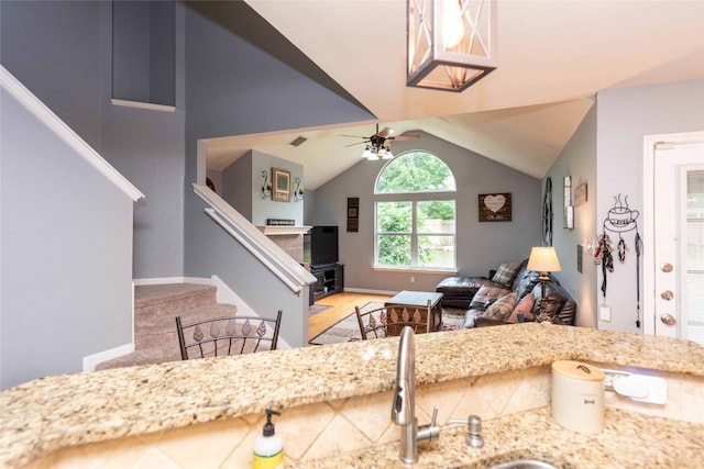 1006 Savanna Ln, Cedar Park, TX 78613 - living room featuring stairway, vaulted ceiling, a ceiling fan, baseboards, and light wood finished floors