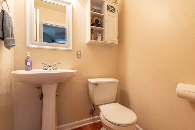 1006 Savanna Ln, Cedar Park, TX 78613 - bathroom featuring toilet, baseboards, and wood finished floors