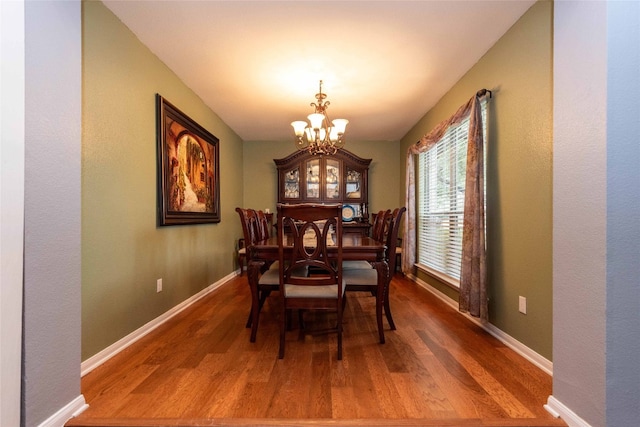 1006 Savanna Ln, Cedar Park, TX 78613 - dining area with a chandelier, wood finished floors, and baseboards