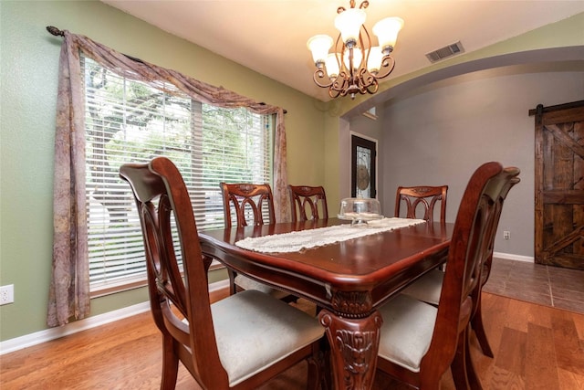 1006 Savanna Ln, Cedar Park, TX 78613 - dining space featuring arched walkways, wood finished floors, plenty of natural light, and a chandelier