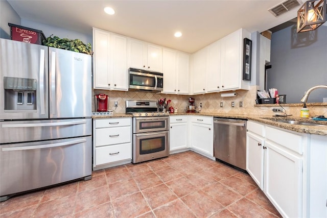 1006 Savanna Ln, Cedar Park, TX 78613 - kitchen featuring stainless steel appliances, tasteful backsplash, white cabinets, light stone countertops, and recessed lighting