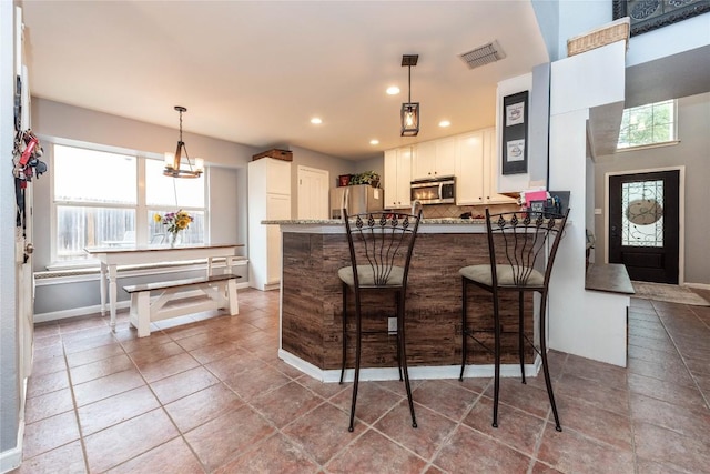 1006 Savanna Ln, Cedar Park, TX 78613 - kitchen with appliances with stainless steel finishes, healthy amount of natural light, backsplash, a peninsula, and recessed lighting