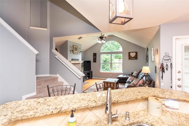 1006 Savanna Ln, Cedar Park, TX 78613 - living area with vaulted ceiling, stairway, ceiling fan, and light wood-style flooring