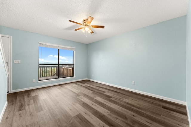 21459 Coyote Trl Unit A2, Lago Vista, TX 78645 - empty room with a ceiling fan, wood finished floors, and a textured ceiling