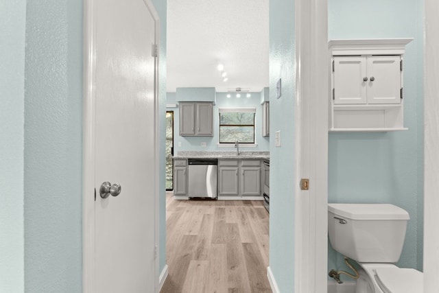 21459 Coyote Trl Unit A2, Lago Vista, TX 78645 - bathroom with toilet, wood finished floors, and vanity