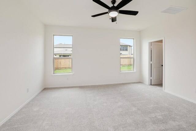 4923 Mozzafiato Ln, Round Rock, TX 78665 - empty room with light carpet, a ceiling fan, and baseboards