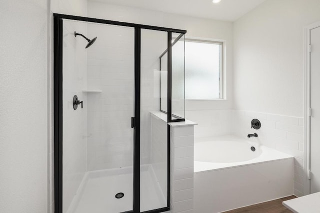 4923 Mozzafiato Ln, Round Rock, TX 78665 - bathroom featuring a shower stall, a garden tub, and wood finished floors