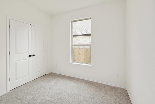 4923 Mozzafiato Ln, Round Rock, TX 78665 - unfurnished bedroom with carpet flooring, a closet, and baseboards