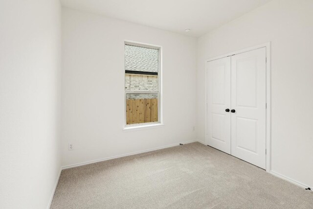 4923 Mozzafiato Ln, Round Rock, TX 78665 - unfurnished bedroom with light carpet, a closet, and baseboards