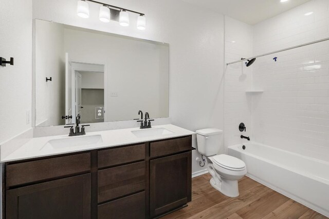 4923 Mozzafiato Ln, Round Rock, TX 78665 - bathroom with toilet, wood finished floors, double vanity, and shower / bath combination