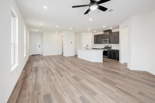 4923 Mozzafiato Ln, Round Rock, TX 78665 - unfurnished living room with a sink, a ceiling fan, recessed lighting, light wood-type flooring, and baseboards