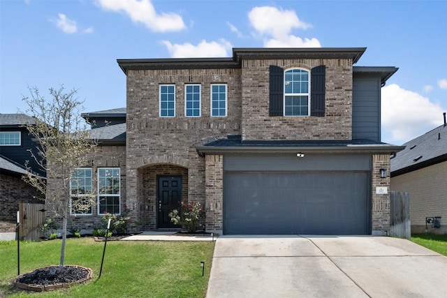 707 Sugar Cane Rd, Buda, TX 78610 - view of front of home with a garage, a front yard, driveway, and brick siding