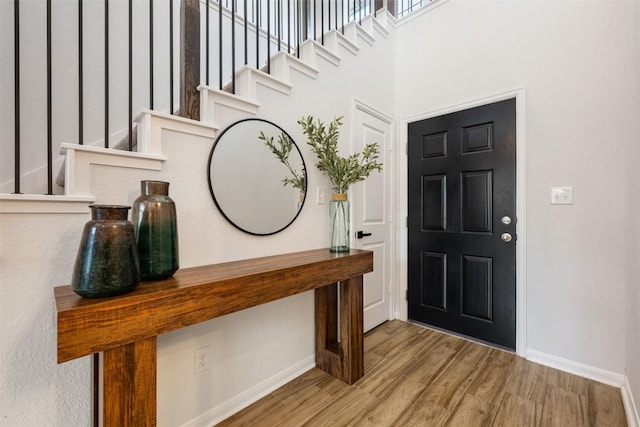 707 Sugar Cane Rd, Buda, TX 78610 - entryway with baseboards, wood finished floors, and stairs