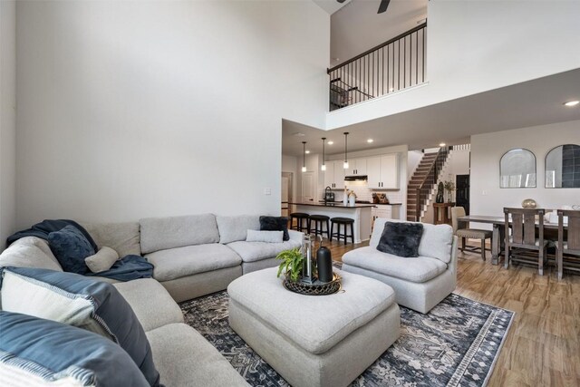707 Sugar Cane Rd, Buda, TX 78610 - living area with light wood finished floors, stairs, and a high ceiling