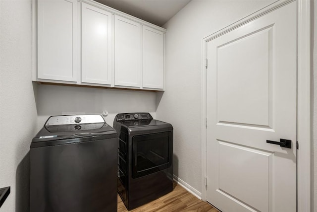 707 Sugar Cane Rd, Buda, TX 78610 - washroom featuring cabinet space, independent washer and dryer, light wood-type flooring, and baseboards