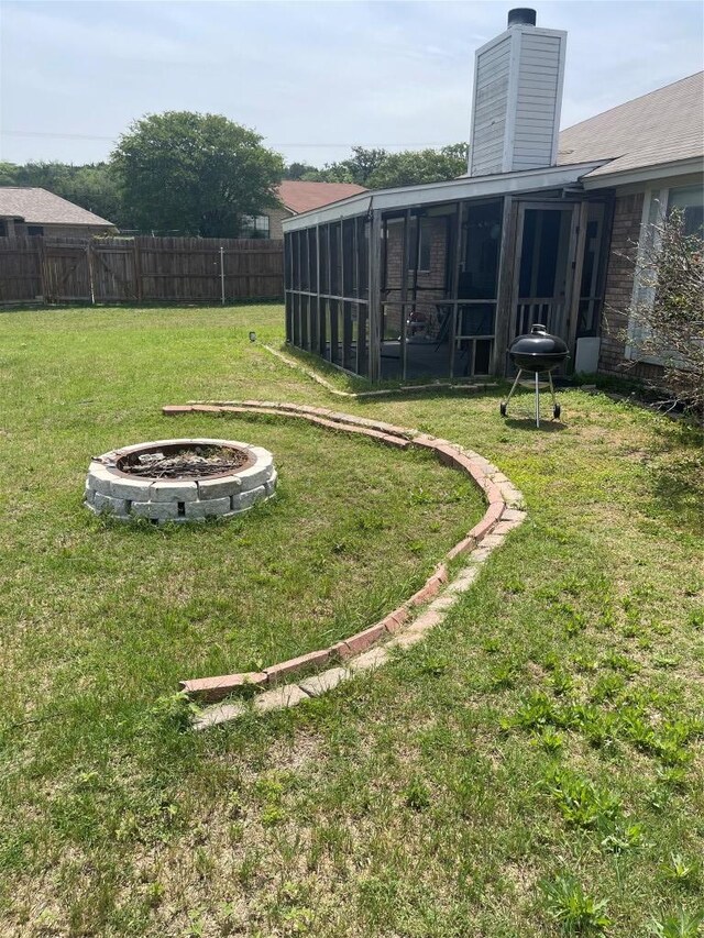 907 Vernon Dr, Copperas Cove, TX 76522 - view of yard featuring a sunroom and an outdoor fire pit