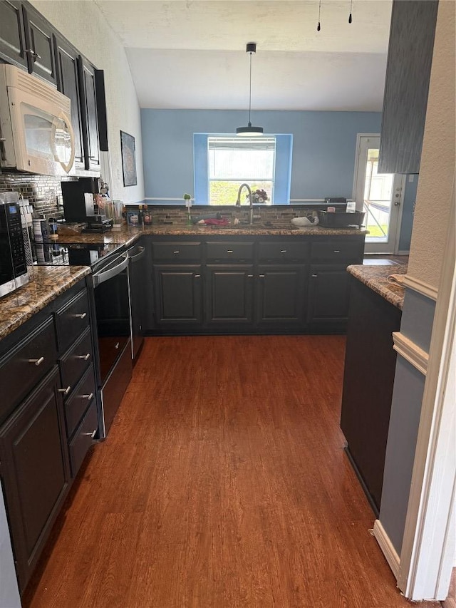 907 Vernon Dr, Copperas Cove, TX 76522 - kitchen with appliances with stainless steel finishes, dark wood finished floors, healthy amount of natural light, and dark stone counters