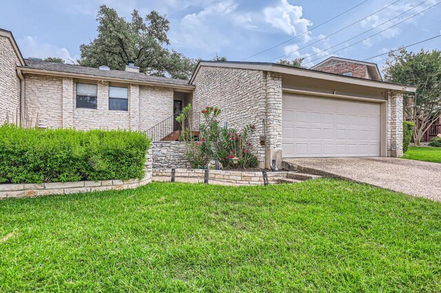 9518 Topridge Dr Unit 7, Austin, TX 78750 - view of front facade with a front yard, driveway, an attached garage, and a chimney