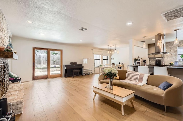 9518 Topridge Dr Unit 7, Austin, TX 78750 - living area with recessed lighting, light wood-style flooring, healthy amount of natural light, and a textured ceiling