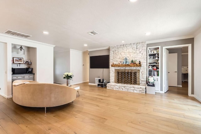 9518 Topridge Dr Unit 7, Austin, TX 78750 - living room with ornamental molding, hardwood / wood-style flooring, a fireplace, built in shelves, and recessed lighting