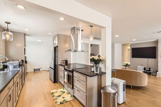 9518 Topridge Dr Unit 7, Austin, TX 78750 - kitchen featuring stainless steel appliances, wall chimney exhaust hood, dark countertops, light wood-type flooring, and recessed lighting