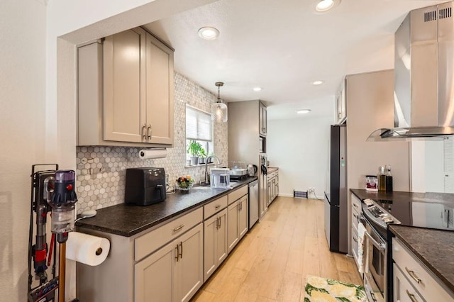 9518 Topridge Dr Unit 7, Austin, TX 78750 - kitchen with wall chimney exhaust hood, appliances with stainless steel finishes, decorative backsplash, light wood-style floors, and recessed lighting