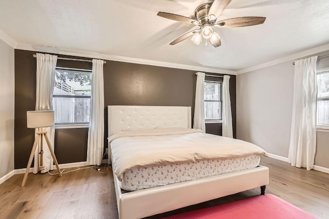 9518 Topridge Dr Unit 7, Austin, TX 78750 - bedroom featuring wood finished floors, ornamental molding, and ceiling fan
