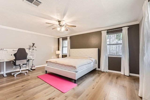 9518 Topridge Dr Unit 7, Austin, TX 78750 - bedroom featuring crown molding, wood finished floors, multiple windows, and ceiling fan