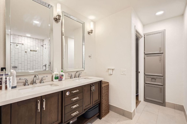 9518 Topridge Dr Unit 7, Austin, TX 78750 - bathroom featuring double vanity, tiled shower, tile patterned flooring, and recessed lighting