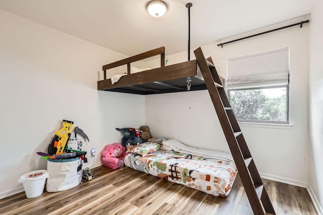 9518 Topridge Dr Unit 7, Austin, TX 78750 - bedroom featuring wood finished floors and baseboards
