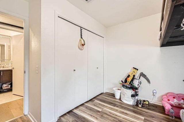 9518 Topridge Dr Unit 7, Austin, TX 78750 - bedroom featuring light wood finished floors and a closet