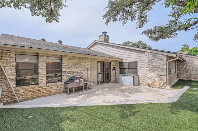 9518 Topridge Dr Unit 7, Austin, TX 78750 - rear view of property with stone siding, a patio area, a lawn, a chimney, and a shingled roof