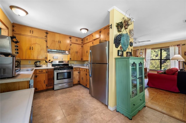 10908 Slaughter Creek Dr, Austin, TX 78748 - kitchen with stainless steel appliances, under cabinet range hood, light countertops, light tile patterned flooring, and ceiling fan