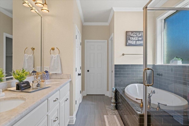 1409 Old Mill Rd, Salado, TX 76571 - full bathroom with crown molding, double vanity, a bath, wood finished floors, and a shower stall
