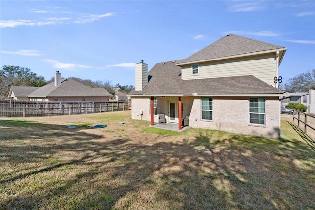 1409 Old Mill Rd, Salado, TX 76571 - rear view of house with a chimney, a patio, and roof with shingles