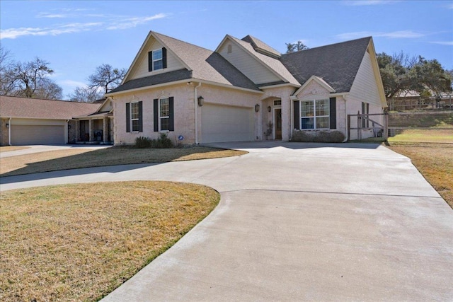 1409 Old Mill Rd, Salado, TX 76571 - view of front facade featuring curved driveway, a garage, and brick siding