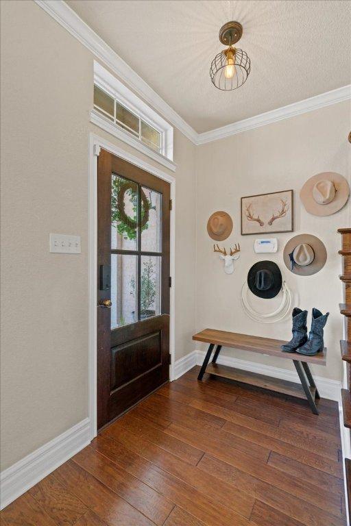 1409 Old Mill Rd, Salado, TX 76571 - entrance foyer with ornamental molding, baseboards, and wood finished floors