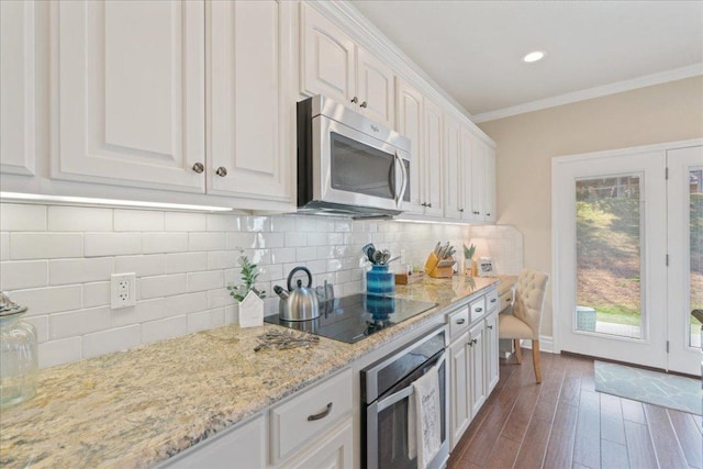 1409 Old Mill Rd, Salado, TX 76571 - kitchen featuring stainless steel appliances, white cabinets, dark wood finished floors, light stone countertops, and ornamental molding