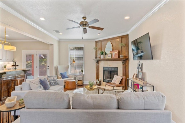 1409 Old Mill Rd, Salado, TX 76571 - living room with ceiling fan, a fireplace, recessed lighting, crown molding, and wood finished floors