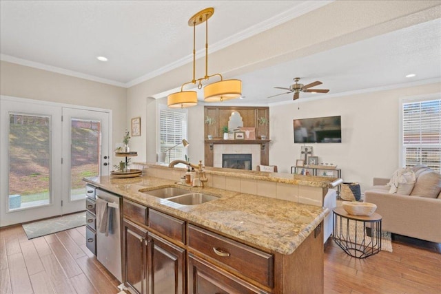 1409 Old Mill Rd, Salado, TX 76571 - kitchen with a sink, open floor plan, dishwasher, wood-type flooring, and a center island with sink