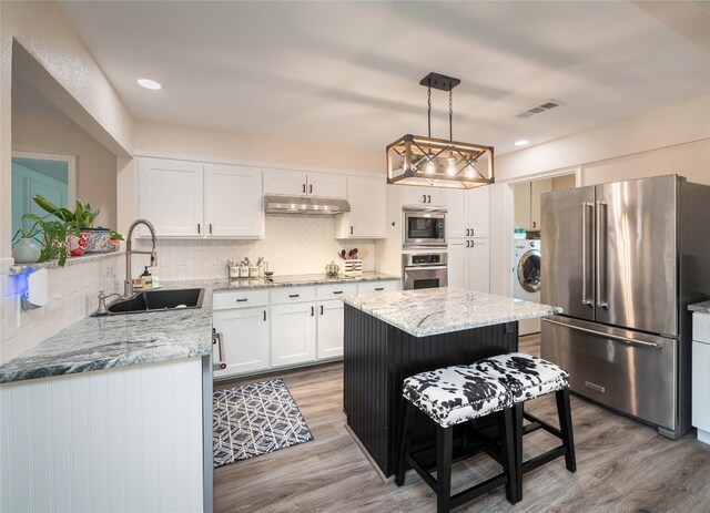 2702 Double Tree St, Round Rock, TX 78681 - kitchen featuring stainless steel appliances, a sink, light wood-style flooring, white cabinets, and recessed lighting