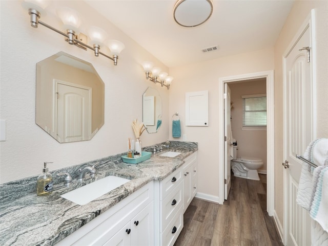 2702 Double Tree St, Round Rock, TX 78681 - full bath with wood finished floors, double vanity, toilet, and baseboards
